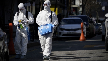 Employees from a disinfection service company sanitize a shopping district in Seoul, South Korea, on Feb. 27, 2020.