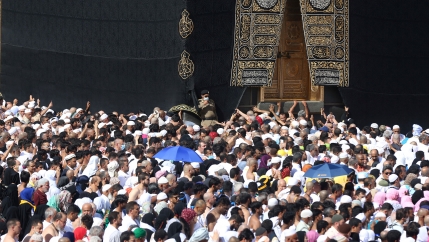 A police officer wears a face mask to prevent contracting coronavirus, as Muslim pilgrims pray at Kaaba in the Grand mosque in the holy city of Mecca, Saudi Arabia, on Feb. 27, 2020. 
