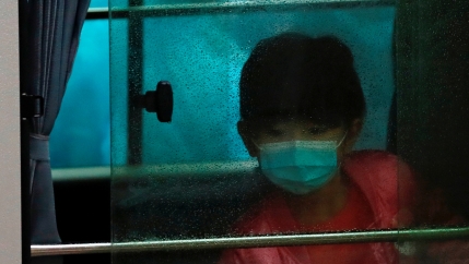 A child wears a face mask