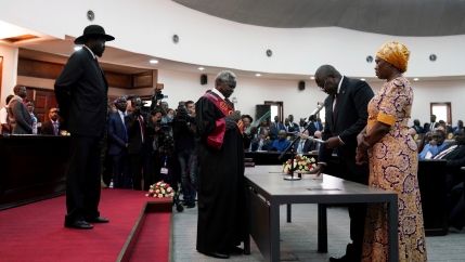 South Sudan's First Vice President Riek Machar takes the oath of office in front of President Salva Kiir and Chief Justice Chan Reech Madut at the State House in Juba, South Sudan, Feb. 22, 2020.