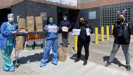 Filipino nurses on the front lines of the coronavirus pandemic at Elmhurst Hospital in Queens, New York City, pose with donated food from Meals to Heal, a Filipino American community initiative.