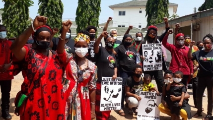 People with signs and raising fists