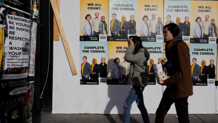 Signs advertising the 2020 US Census cover a closed and boarded up business amid the coronavirus outbreak in Seattle, Washington, March 23, 2020.