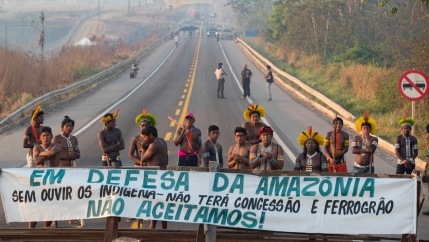 Kayapó Indigenous protesters block highway BR-163 with a banner that reads in Portuguese 