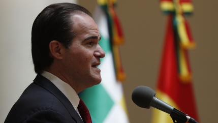 A man in a suit speaks in public