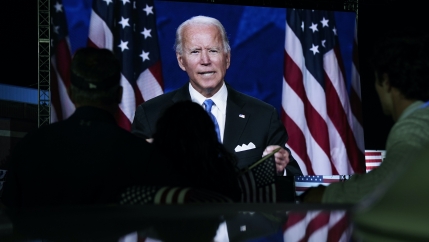 In this Aug. 20, 2020, file photo supporters watch the program outside the venue where Democratic presidential candidate former Vice President Joe Biden is speaking, during the Democratic National Convention at the Chase Center in Wilmington, Delaware.