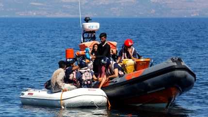 A small inflatable boat carrying migrants from Afghanistan is towed by a rescue vessel of the Refugee Rescue NGO, near Skala Sikamias, on the island of Lesbos, Greece, Sept. 16, 2019.