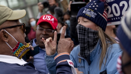 Trump supporters at right argue with a counterprotester at left as they protest election results outside the central counting board at the TCF Center in Detroit, Michigan, Nov. 5, 2020.