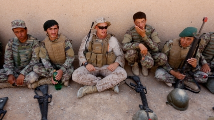 A US Marine (center) talks with Afghan National Army (ANA) soldiers during a training in Helmand province, Afghanistan, July 5, 2017.