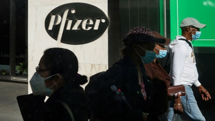 People walk past Pfizer world headquarters in New York City, Nov. 9, 2020.
