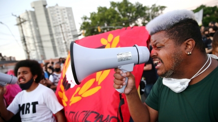 A demonstrator reacts during a protest against racism after João Alberto Silveira Freitas was beaten to death by security guards at a Carrefour supermarket in Porto Alegre, Brazil, Nov. 23, 2020. 