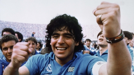 Argentine soccer superstar Diego Armando Maradona cheers after the Napoli team clinched its first Italian major league title in Naples, Italy, on May 10, 1987.