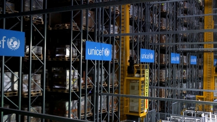 Rows of tall storage columns are show in a UNICEF warehouse.