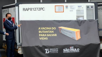 São Paulo Governor João Doria points to a container carrying the experimental COVID-19 vaccine CoronaVac during a photo opportunity, after it was unloaded from a cargo plane that arrived from China at Guarulhos International Airport near São Paulo, Brazil