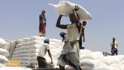 In this file photo, men deliver UN World Food Program (WFP) aid in Aslam, Hajjah, Yemen, Sept. 21, 2018.