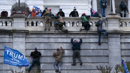 Supporters of President Donald Trump climb the West wall of the the US Capitol on Wednesday, Jan. 6, 2021, in Washington, DC.