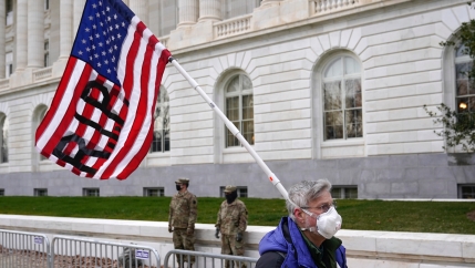 A protester walks past the Russell Senate Office Building on Capitol Hill in Washington, Friday, Jan. 8, 2021.