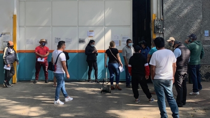 People wait in a long line at an oxygen distribution warehouse near downtown Mexico City.