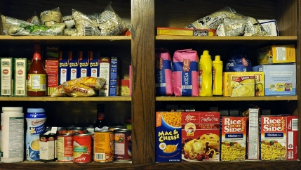 A pantry cabinet with a variety of food packages
