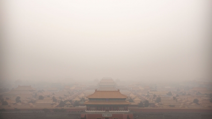 The top of a palace building in China's Forbidden City is barely viewable in a photograph showing a dense amount of smog.