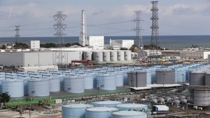 Nuclear reactors of No. 5, center left, and 6 look over tanks storing water that was treated but still radioactive, at the Fukushima Daiichi nuclear power plant