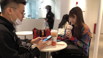 Two people enjoy bubble tea.