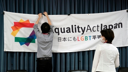 A person is shown clipping a large banner with the words, 
