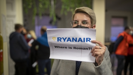 A woman holds a poster reads,
