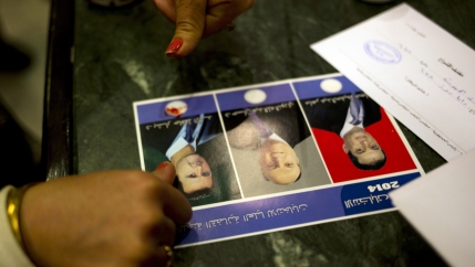A woman votes for President Bashar al-Assad 
