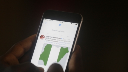 A man used his mobile phone to read headline news on Twitter inside an office in Lagos, Nigeria, Monday, June 7, 2021. 