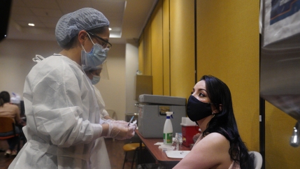 Movistar employee Alejandra Arias, 29, get her first dose of the Sinovac vaccine on July 4.