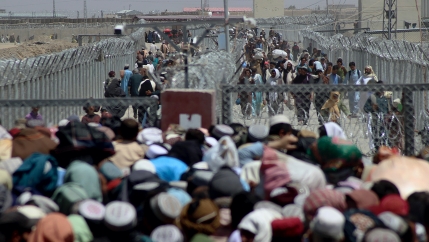 Stranded people crossing the border between Pakistan Afghanistan, in Chaman, Pakistan, Aug. 13, 2021. Pakistan opened its Chaman border crossing for people who had been stranded in recent weeks. Juma Khan, the Pakistan border town's deputy commissioner, s
