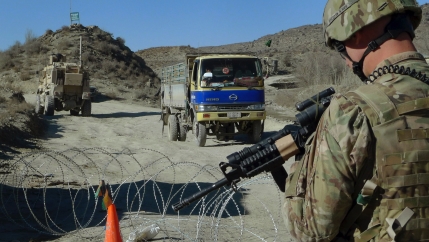 A US soldier with Apache Company of Task Force 3-66 Armor, out of Grafenwoehr, Germany, stands guard at a police checkpoint at Gulruddin pass in Sar Hawza district of Paktika province, south of Kabul, Afghanistan, Dec. 1, 2011.