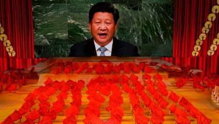 Chinese President Xi Jinping is displayed on a screen as performers dance at a gala show ahead of the 100th anniversary of the founding of the Chinese Communist Party in Beijing