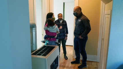 Thuy Do, left, and her husband, Jesse Robbins, right, talk with Abdul, center, Sept. 20, 2021, 