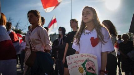 Protesters hold signs