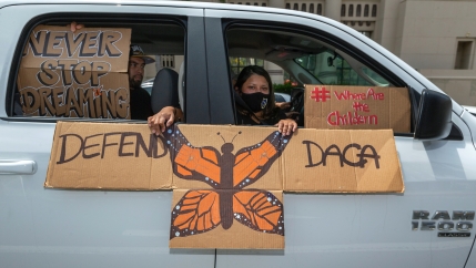 An immigrant family joins members of Coalition for Humane Immigrant Rights of Los Angeles, CHIRLA, on a vehicle caravan rally to support the Deferred Action for Childhood Arrivals Program (DACA), around MacArthur Park in Los Angeles, June 18, 2020. 