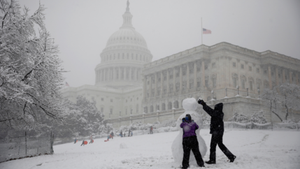 People build a snowman outside the US Capitol in Washington, D.C., March 21, 2018.