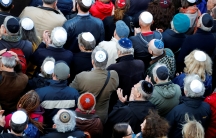 People from different faiths wear kippas as they attend a demonstration on April 25th in front of a Jewish synagogue, to denounce an anti-Semitic attack on a young man wearing a kippa in Berlin earlier in the month.