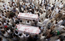 Hazara men carry the coffins of their relatives who were killed after gunmen opened fire on a car, during a funeral ceremony in Quetta, Pakistan, July 19, 2017.