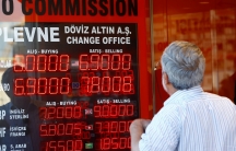 An older man looks to a red display board of a currency exchange office in Istanbul, Turkey, August 13, 2018.