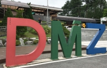 an old building with large DMZ letters out front