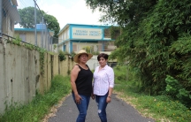 Two women in front of school