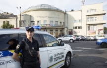 A woman by a police car