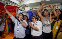 People are show with their arms in the air celebrating after the Supreme Court's verdict of decriminalizing gay sex in India.