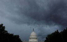 the US capitol under dark clouds
