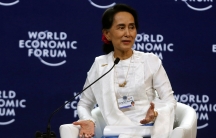 Aung San Suu Kyi on a stage dressed in white
