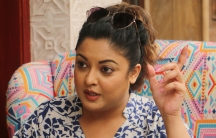 Bollywood actress Tanushree Dutta sits in a chair and gestures as she talks to reporters in Mumbai, India