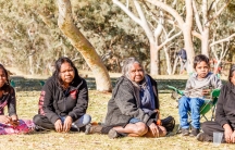 A group of Aboringinal women are shown sitting during a Sunday picnic in Telegraph Station in Alice Springs.
