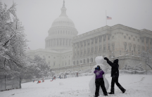 People build a snowman outside the US Capitol in Washington, D.C., March 21, 2018. 
